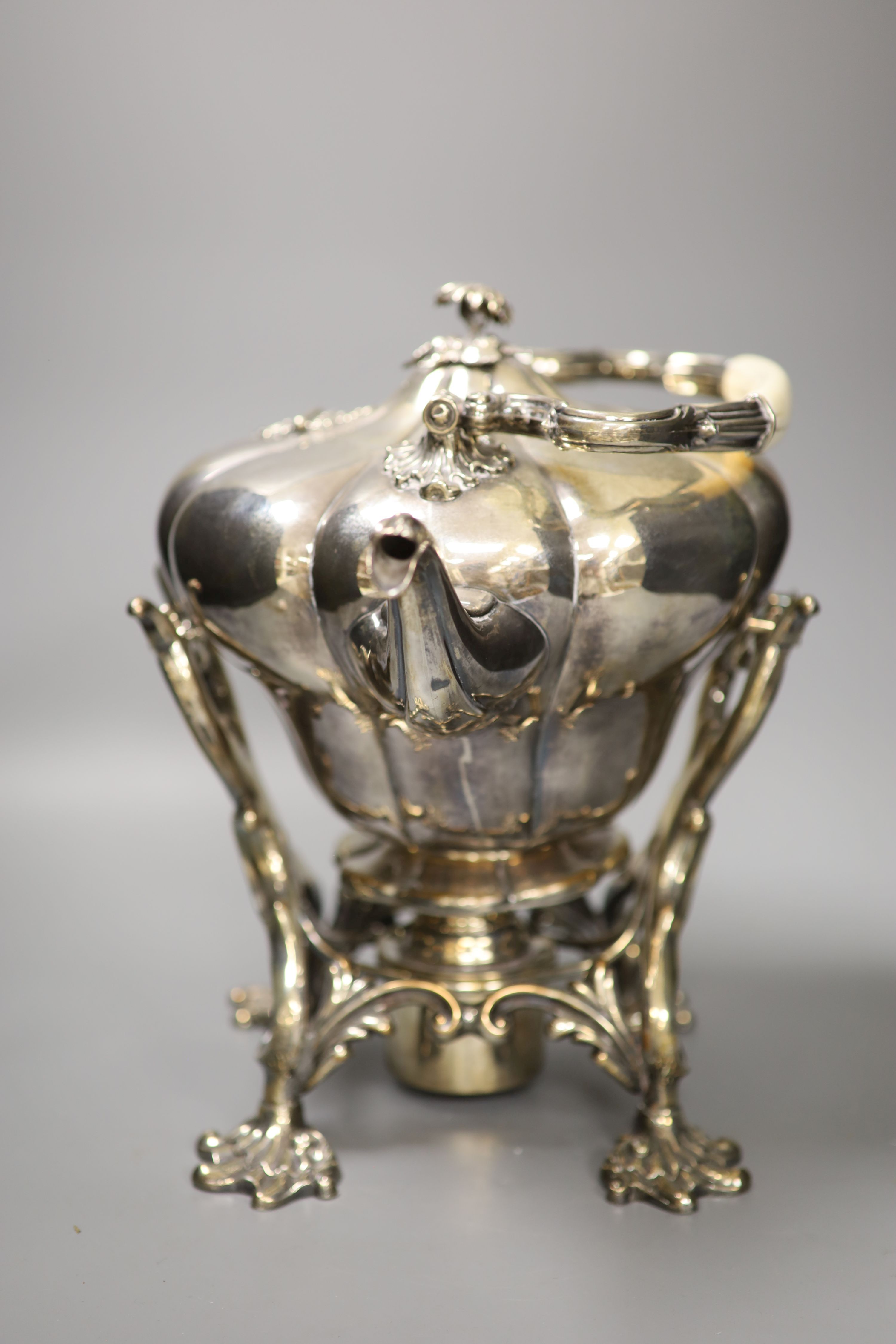A mid 19th century silver plated tea kettle on a burner stand, height with handle down 31cm